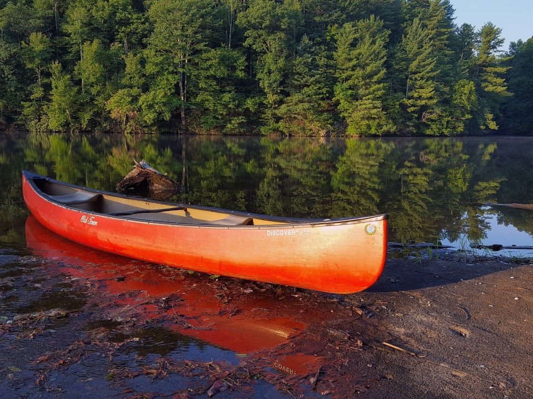 A canoe on the shoreline of a lake